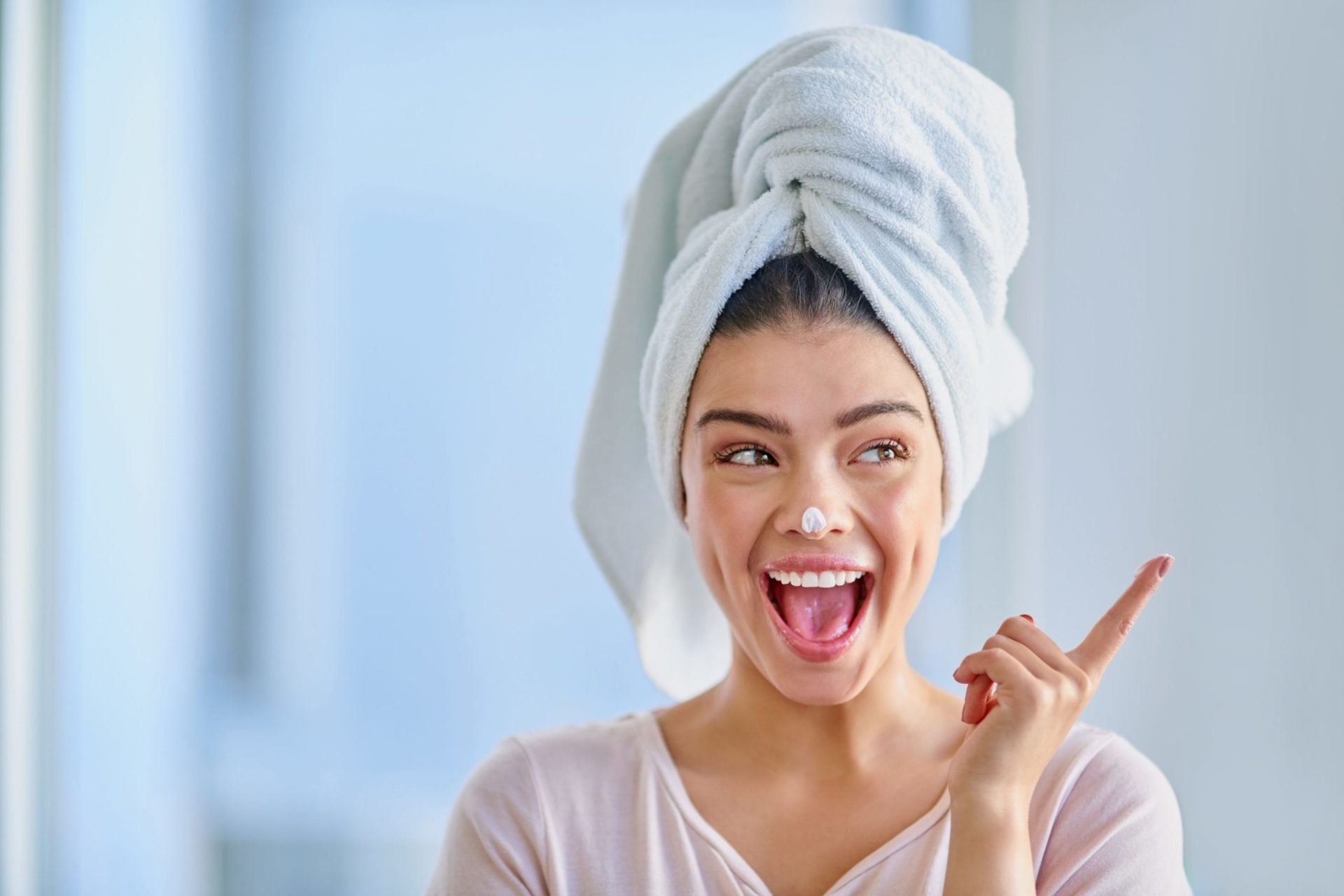 Woman smiling while making her skincare routine