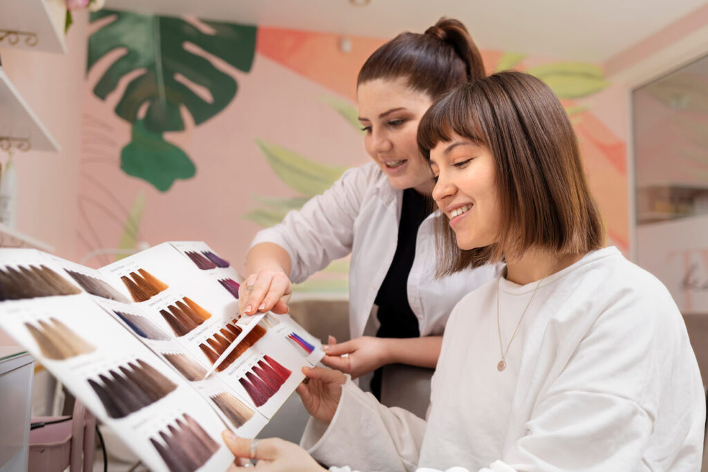 Hairstylist advising client on hair color